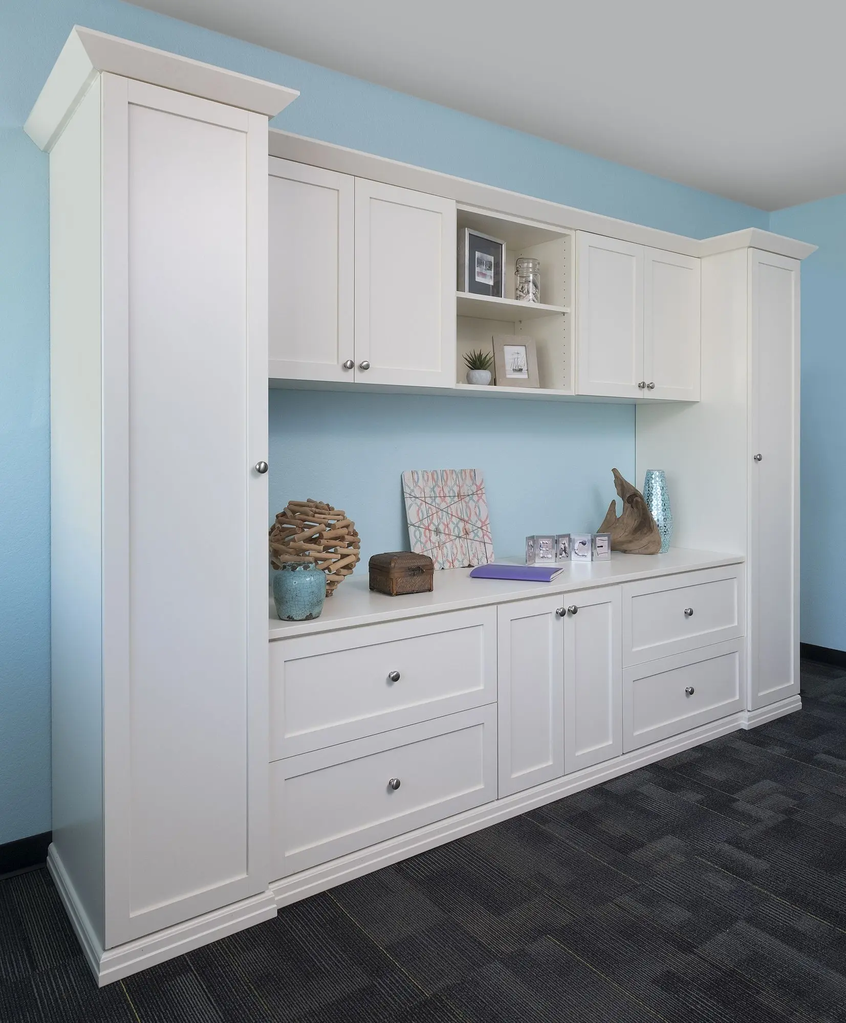 Tall antique white storage cabinets and custom shelving for home office organization