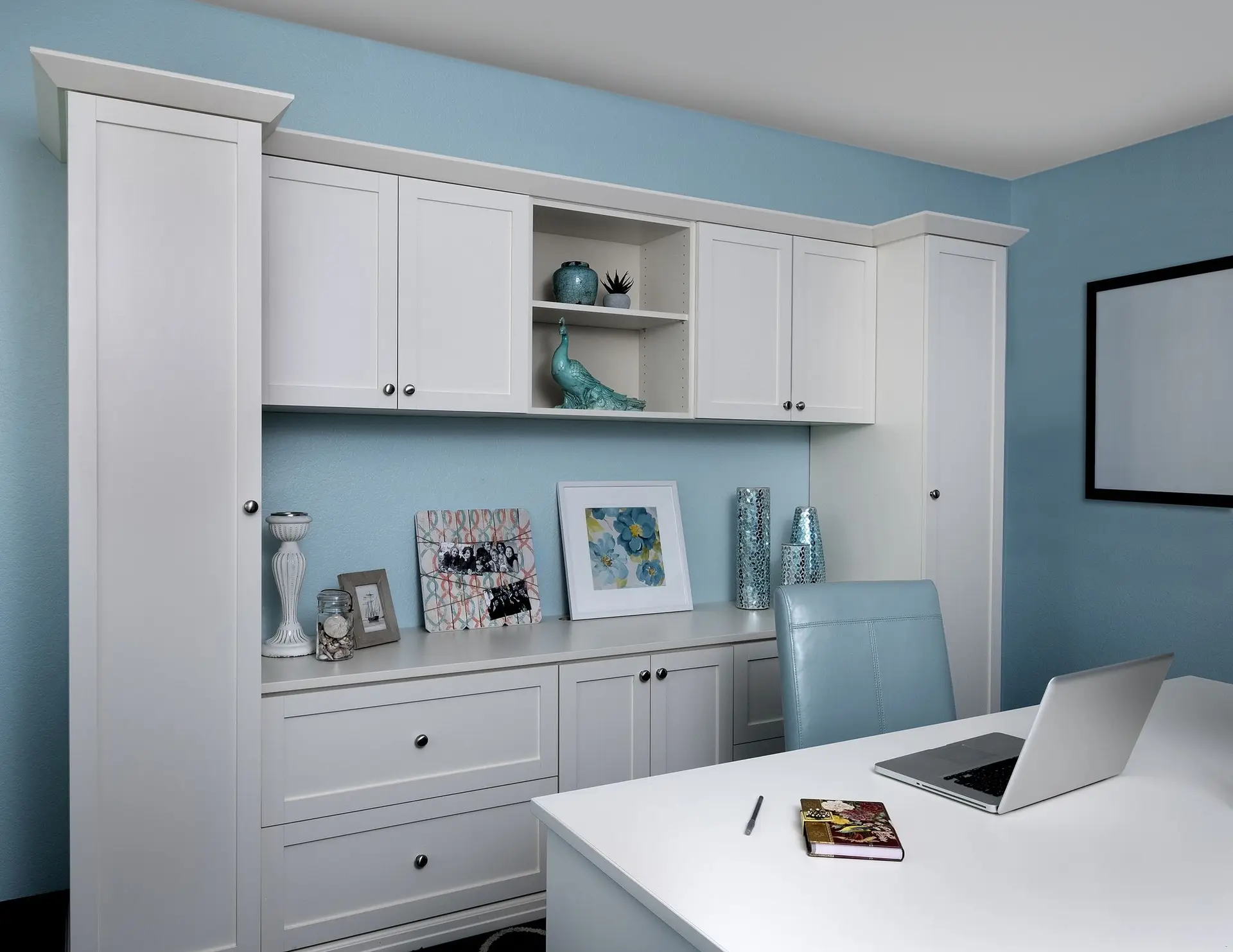 Elegant antique white custom office cabinetry with spacious desktop counter space