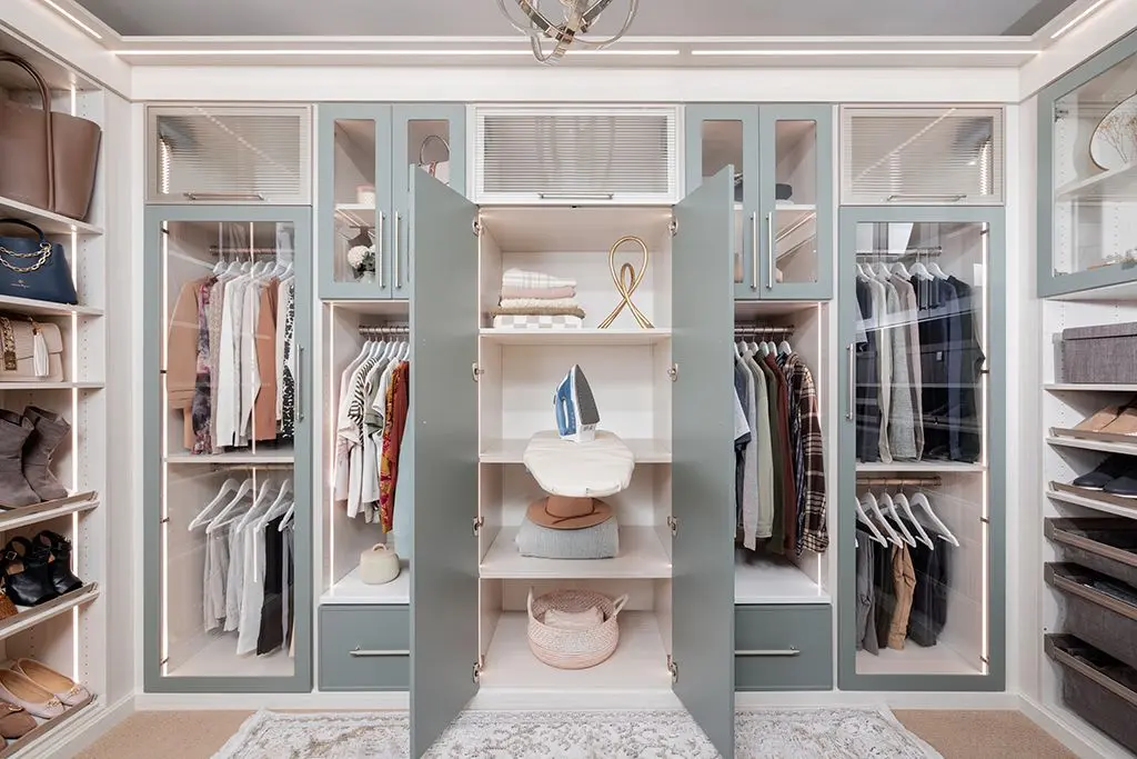 Custom closet systems near me featuring built in lighting and adjustable wardrobe shelves
