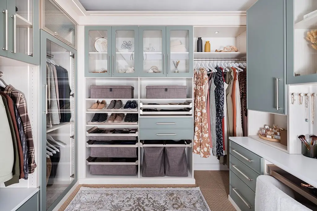 Premium walk-in closet design featuring integrated laundry hamper pull outs and drawers