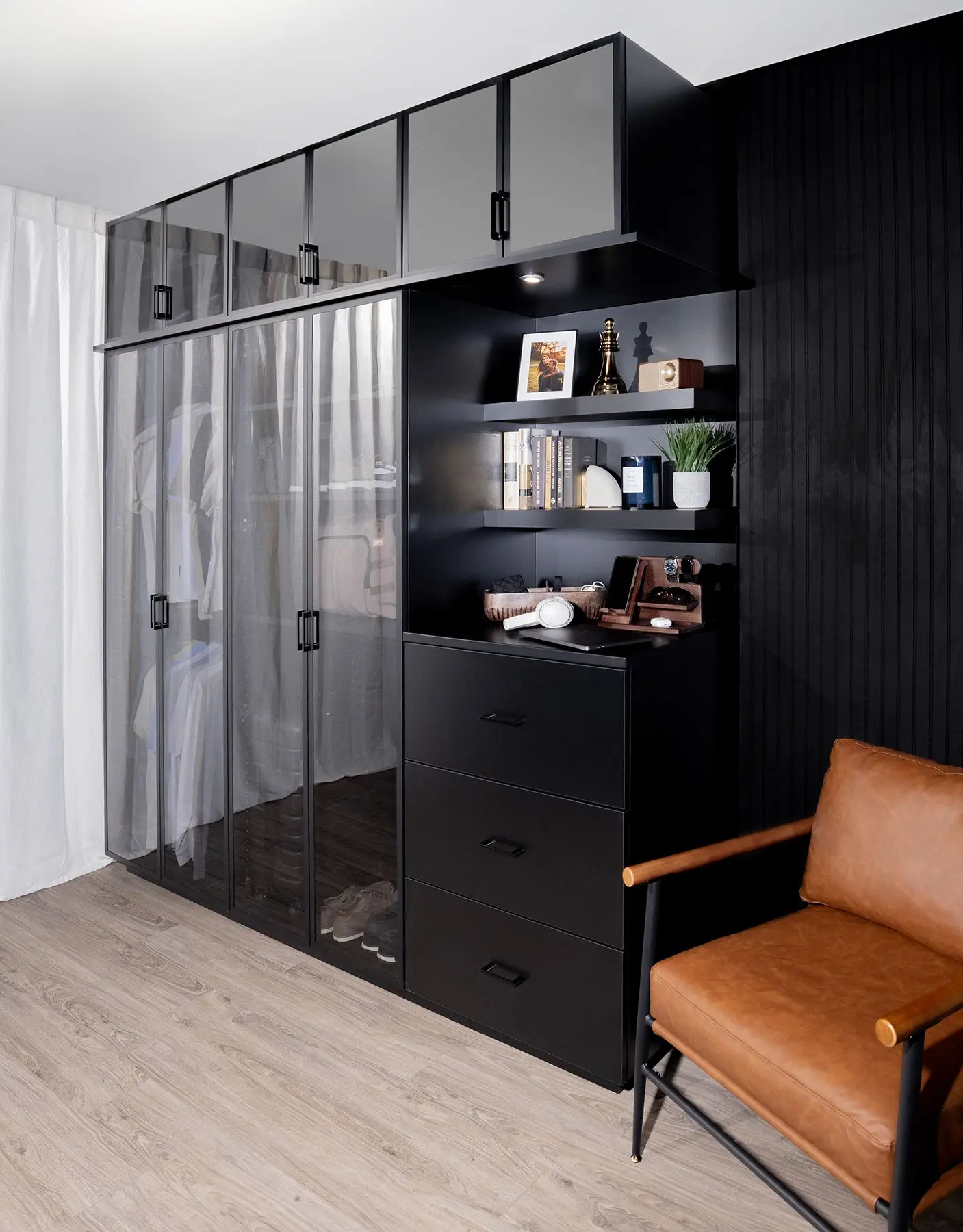 Custom black wardrobe closet and integrated home office setup in Fort Lauderdale