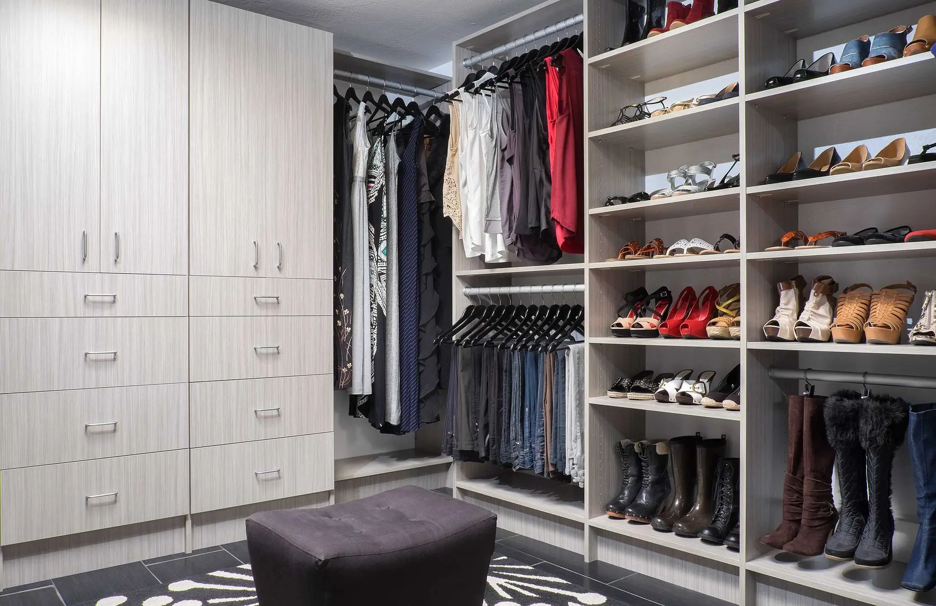 Luxury custom closets showcasing built in drawers and open hanger rods in Boca Raton
