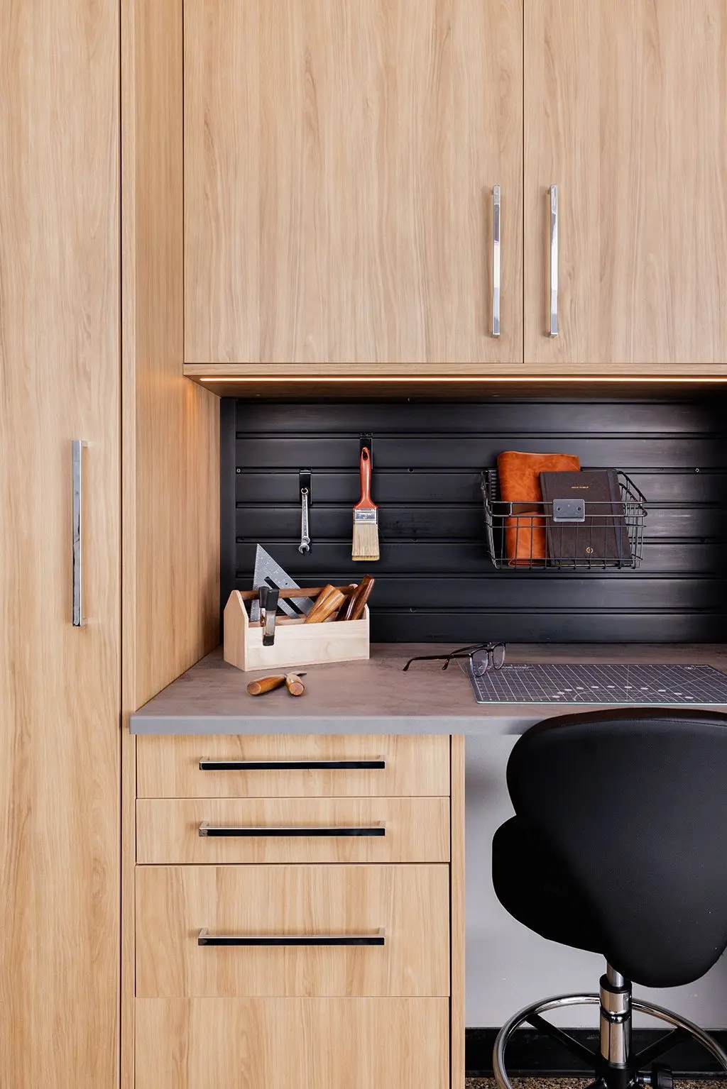 Dakota wood grain garage workbench with integrated drawers and a black tool organizer slatwall