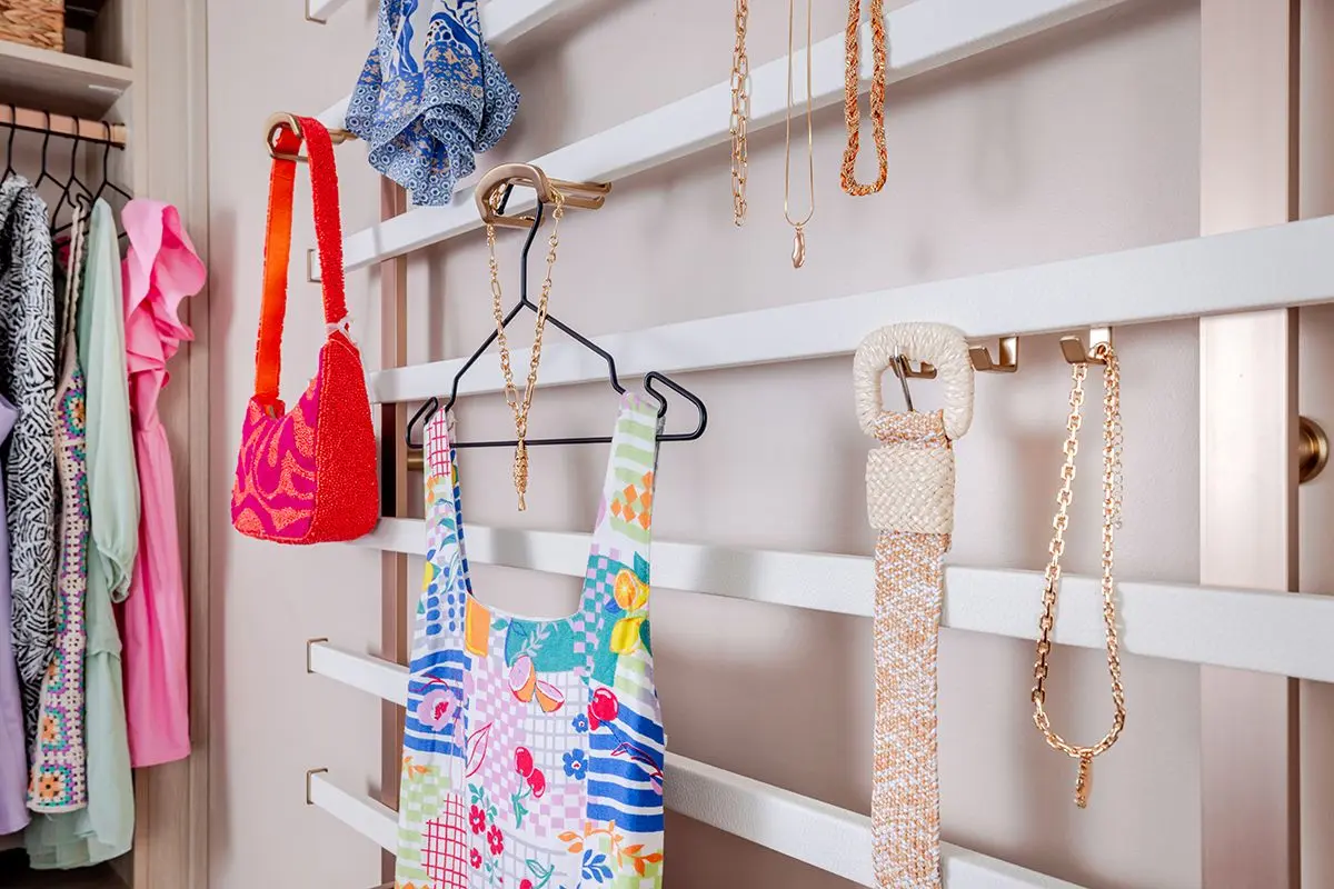 Custom closet systems near me displaying integrated slide-out pants racks