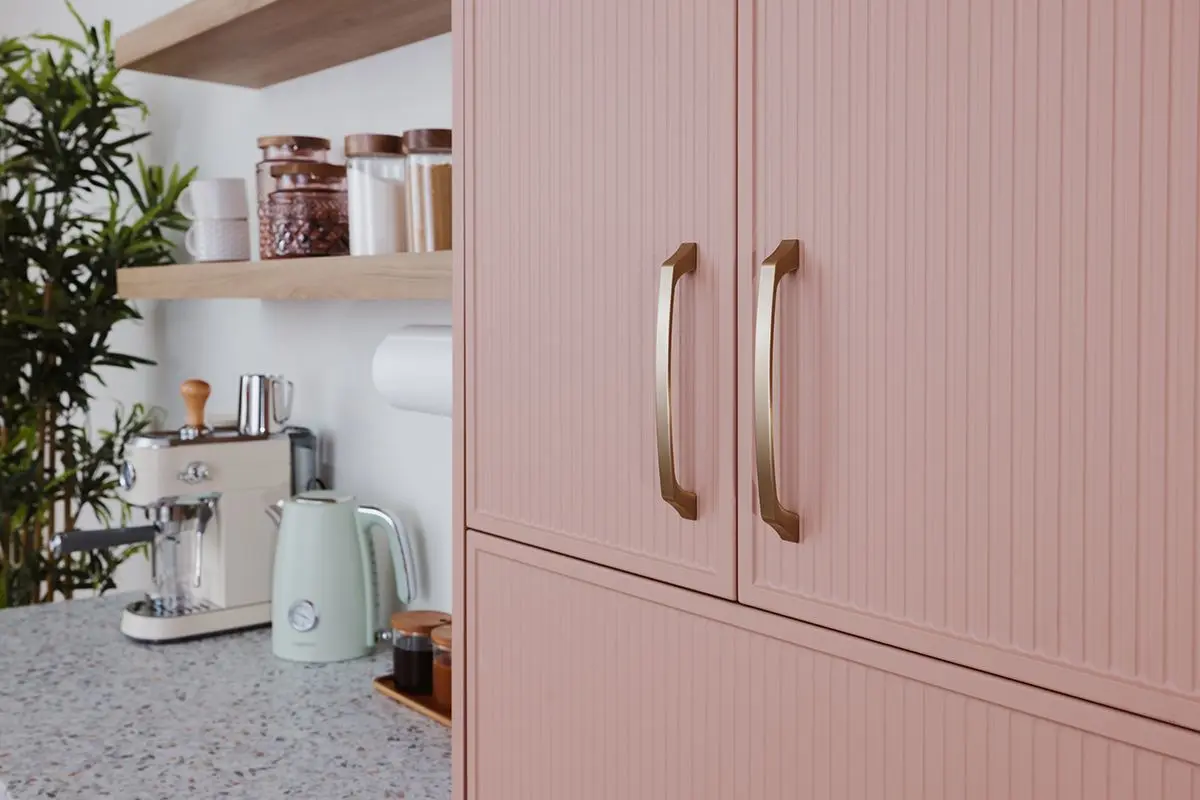 Close up of luxury custom reeded cabinet pull handles and gold hardware details