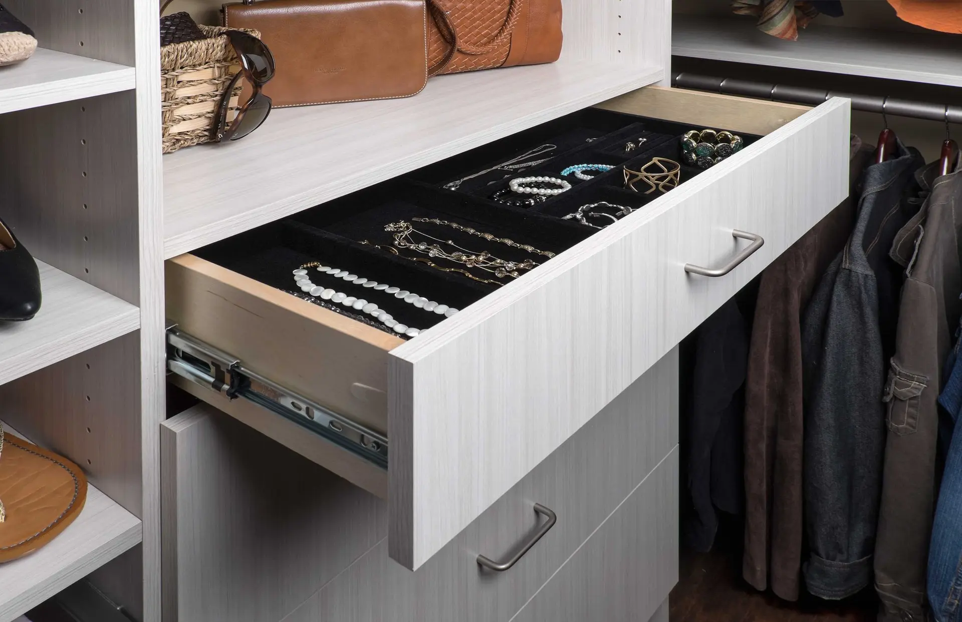 Close up view of an organized jewelry tray with watch and ring storage compartments