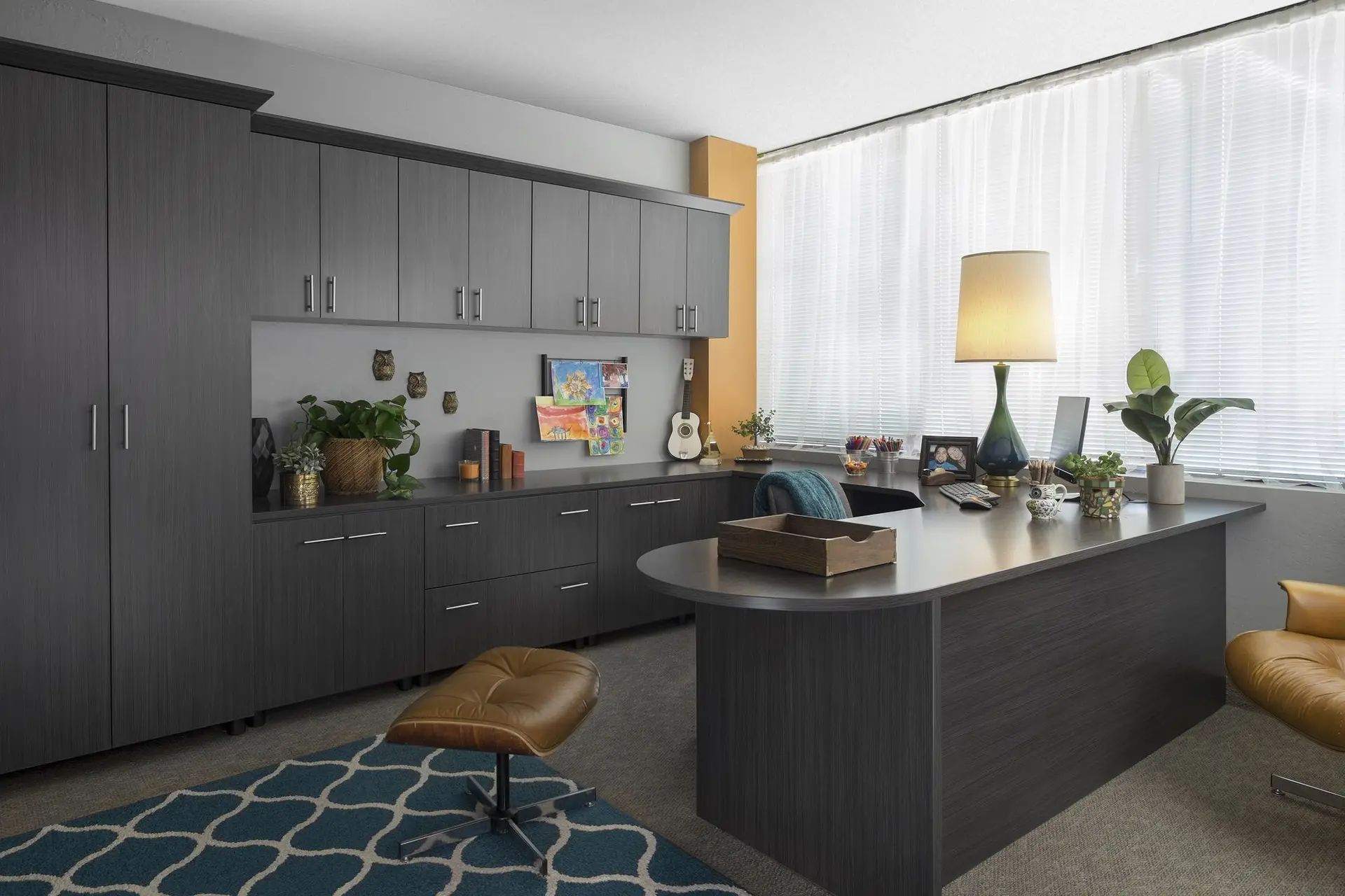 Custom dark grey built in cabinetry and desk for a modern office design in Fort Lauderdale