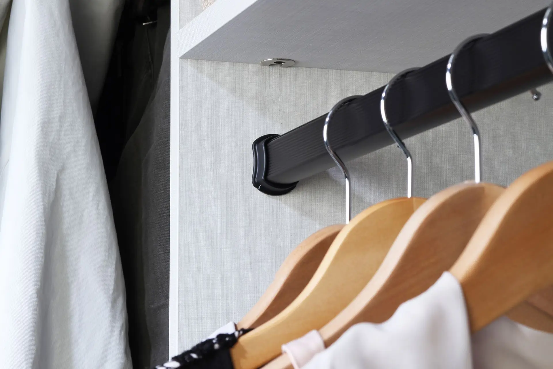 Matte black modern closet clothing pole in a custom closet in South Florida