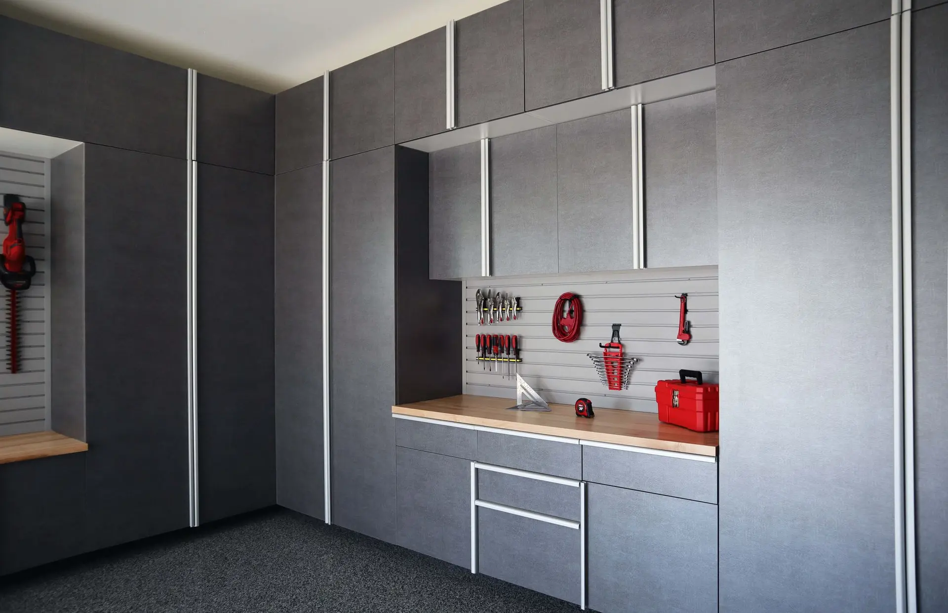 Tall pewter garage closets providing clean hidden home storage capacity
