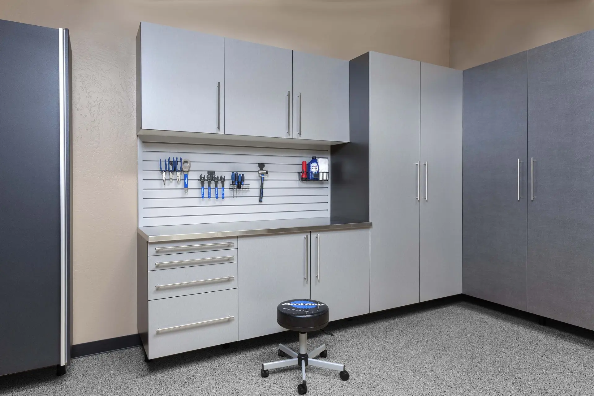 Streamlined silver garage storage layout along a smooth epoxy floor