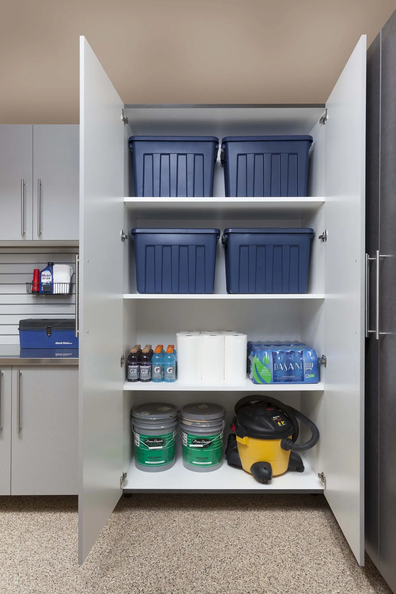 Custom silver garage cabinetry and workstation setup in Weston
