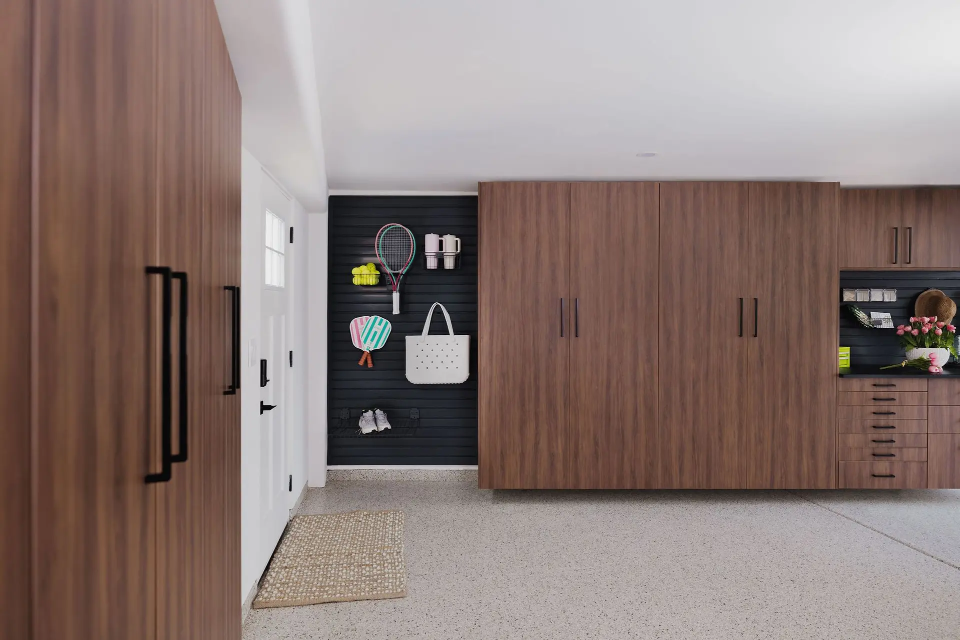 Custom Tahoe finish garage storage cabinets with modern black vertical handles