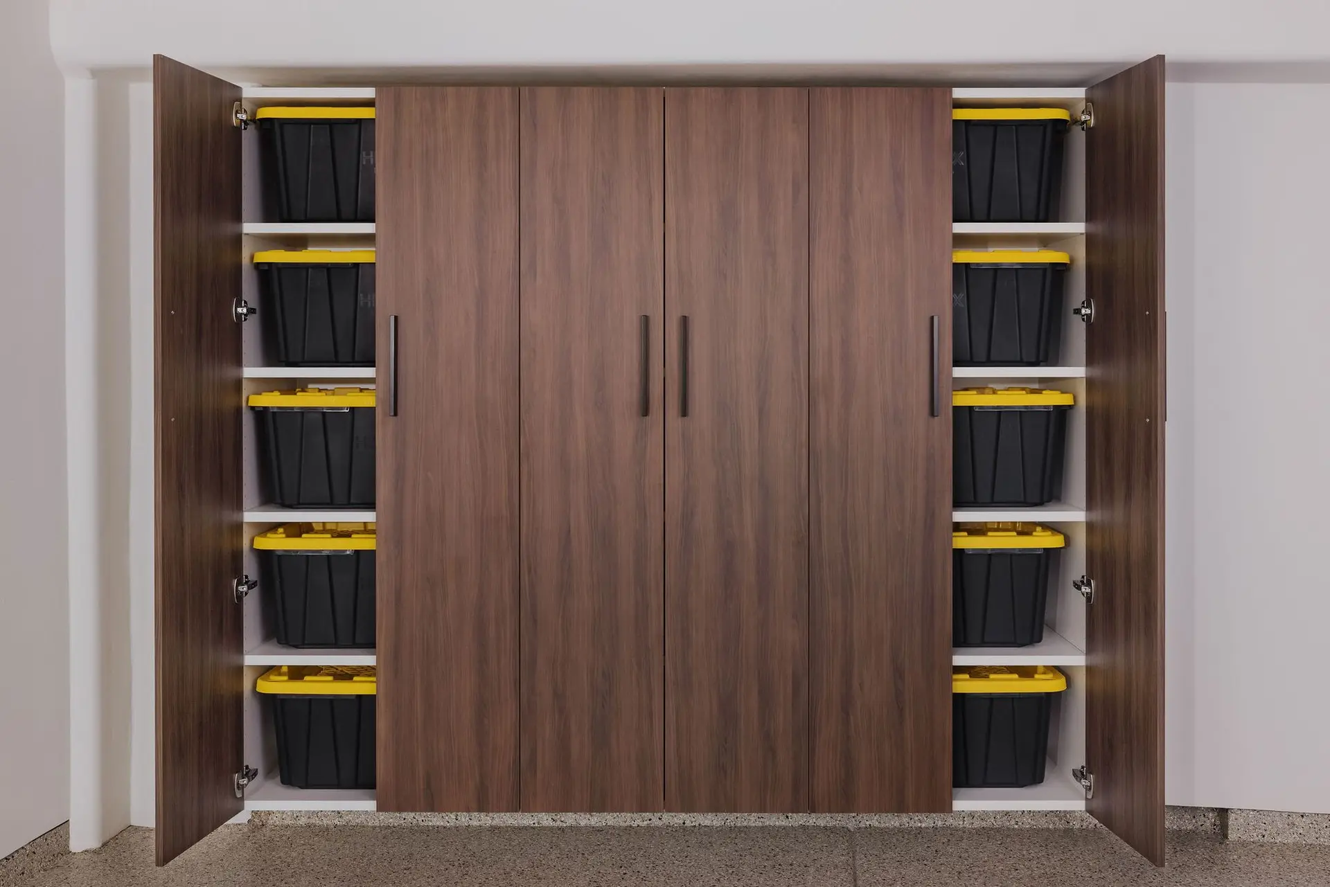 Tall garage storage closets with small interior shelves for tool organization