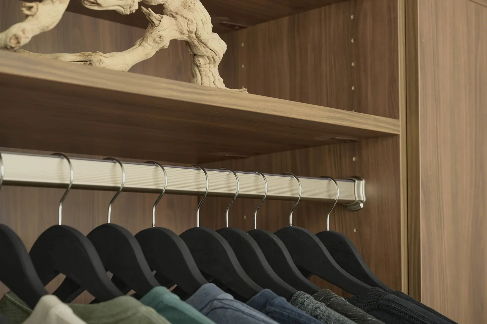 High-end wood finish closet decor and reach-in organization setup in Lighthouse Point