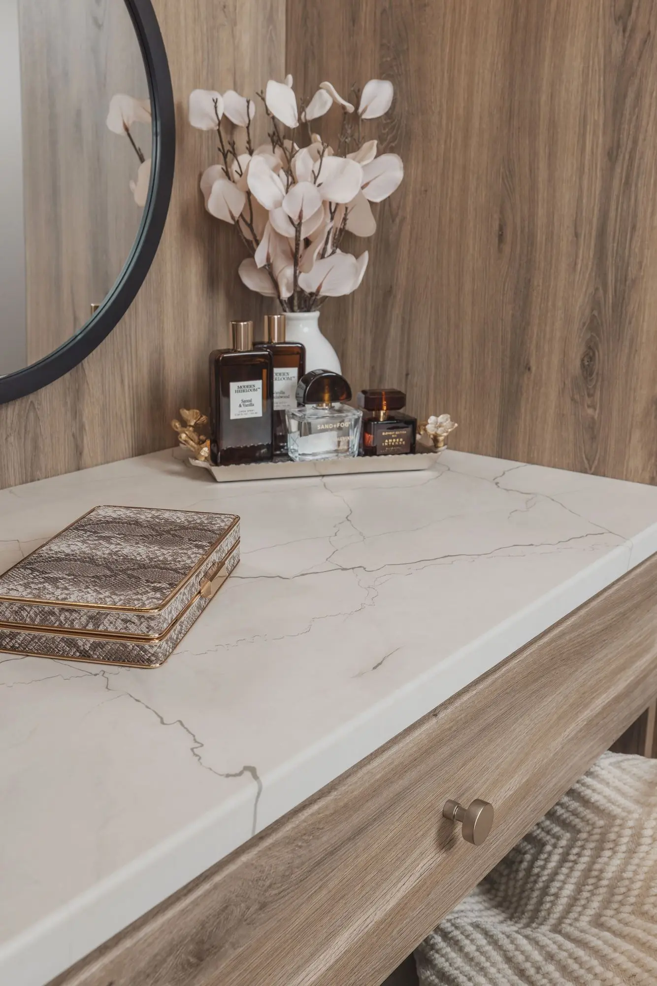 Luxury custom closet vanity featuring a marble countertop and decorative accessories