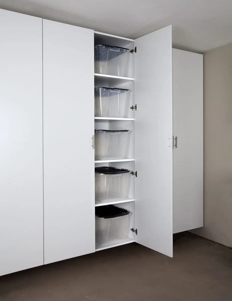 Interior view of tall white garage storage cabinets with adjustable shelves