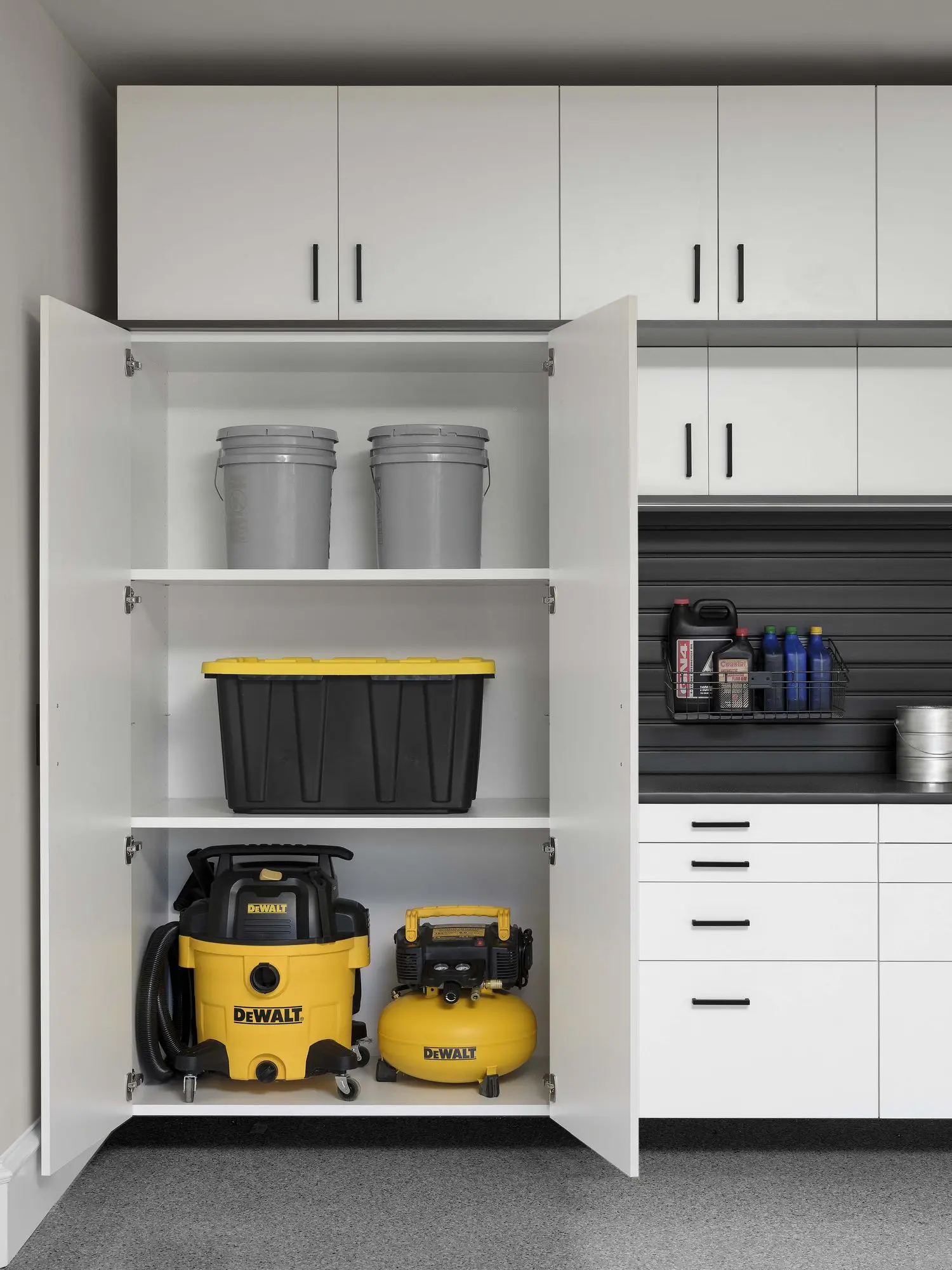 Custom garage storage organization featuring a tool setup and heavy duty shelving
