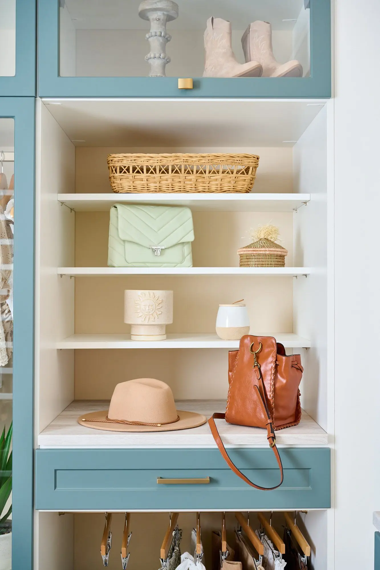 Bespoke home organization system featuring coastal Lagoon tone accent panels