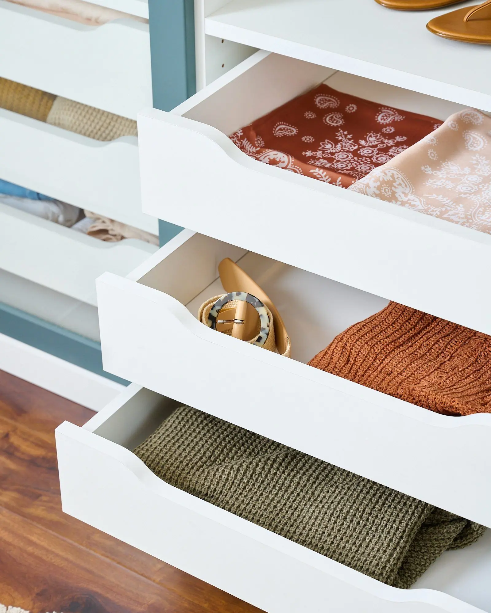 Spacious two-tone walk-in wardrobe layout with clean Lagoon accents