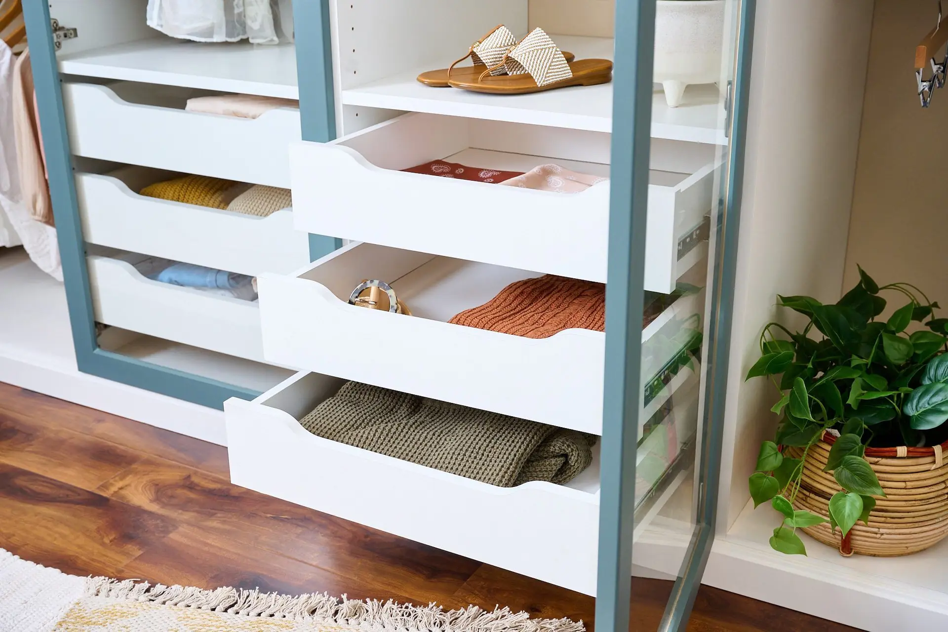 Custom closet organizer system with open shelving and built-in dresser drawers