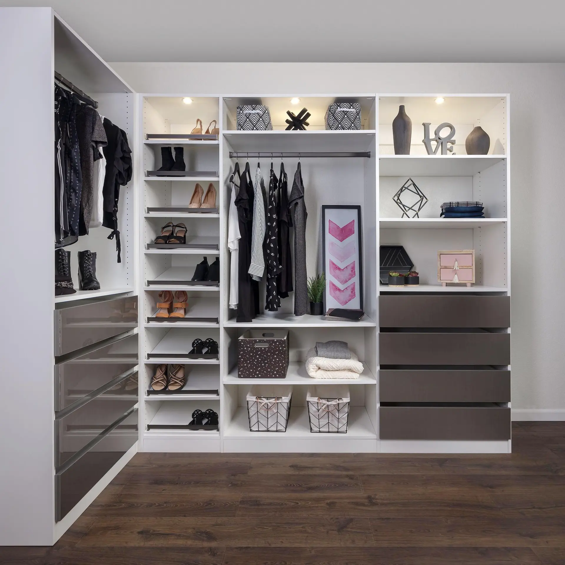 Custom white wardrobe closet with integrated dark drawers and open shelving for clothing organization